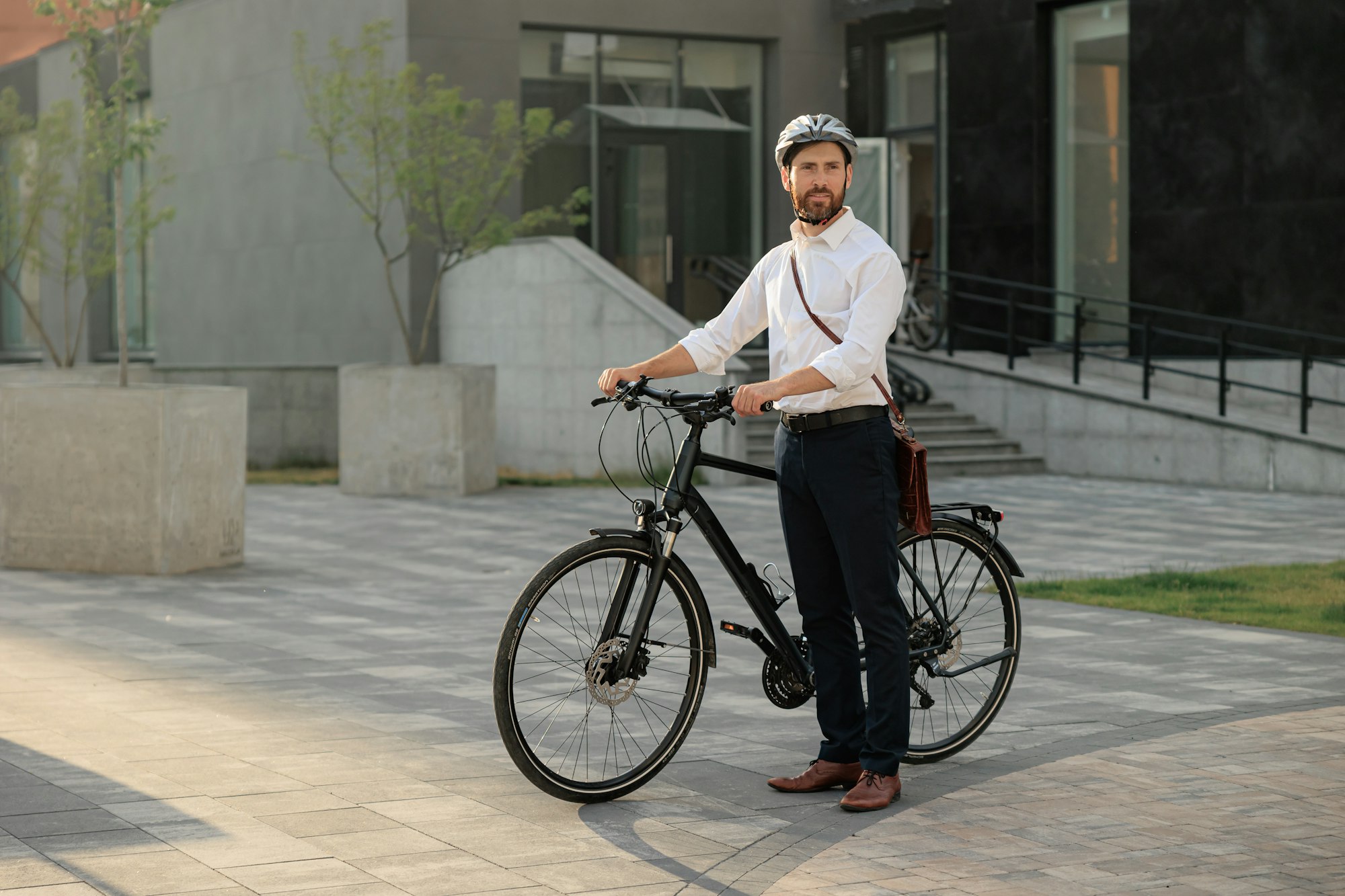 Caucasian businessman commute in shirt with bike outdoors in city.